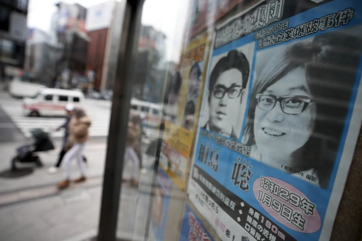 A wanted poster for Satoshi Kirishima, a fugitive who has long been wanted for one of a series of terrorist bombings in Japan, is displayed outside a police station in Tokyo on Feb. 2, 2024. (Eugene Hoshiko/AP Photo)