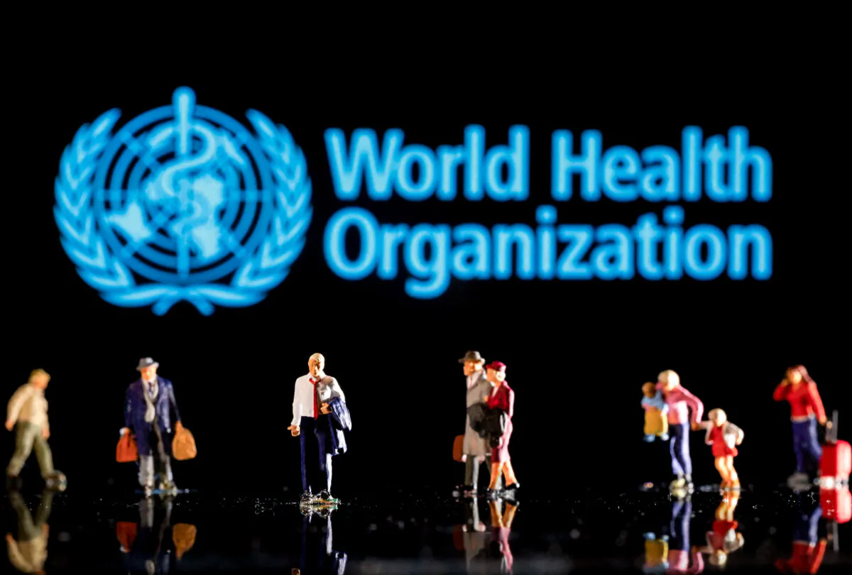 Small figurines are seen in front of the World Health Organization logo in this illustration taken on Feb. 11, 2022. (Dado Ruvic/Reuters)
