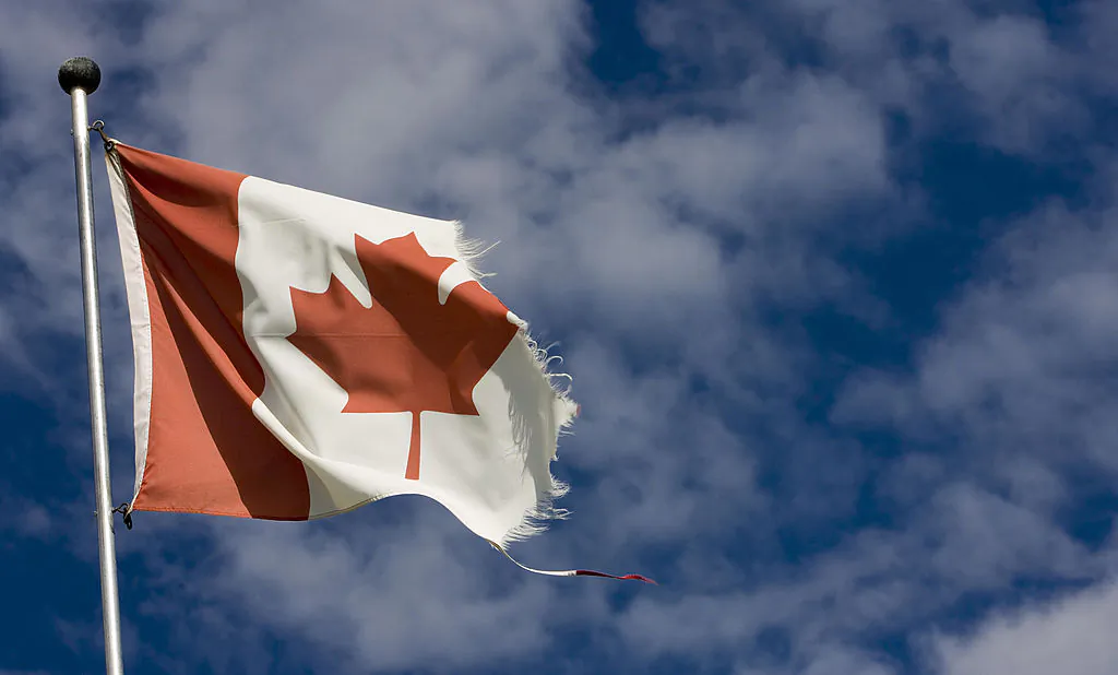 A weathered Canadian flag flutters in Big Valley north of Calgary, Canada, on June 11, 2007. (David Boily/AFP/Getty Images)