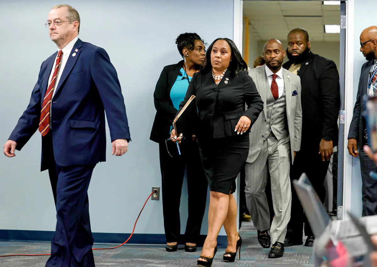 Fulton County District Attorney Fani Willis (C), with outside counsel she hired on the racketeering case against former President Trump, RICO expert John Floyd (L) and Nathan Wade (R). (Joe Raedle/Getty Images)