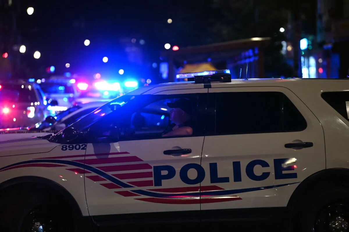 Police cars block a street in Washington on July 22, 2021. (Brendan Smialowski/AFP via Getty Images)