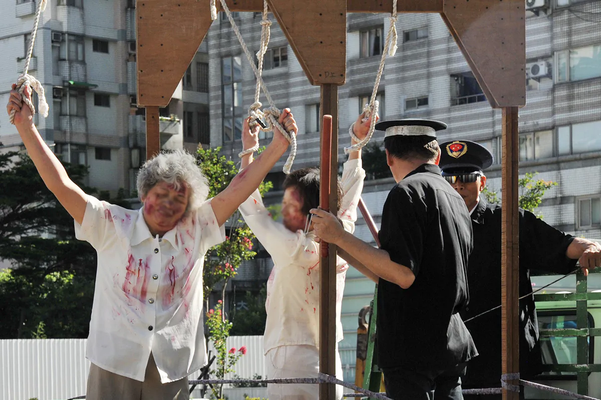 A re-enactment of torture on Falun Gong practitioners during a demonstration in Taipei, Taiwan, on July 20, 2014. (Mandy Cheng/AFP via Getty Images)