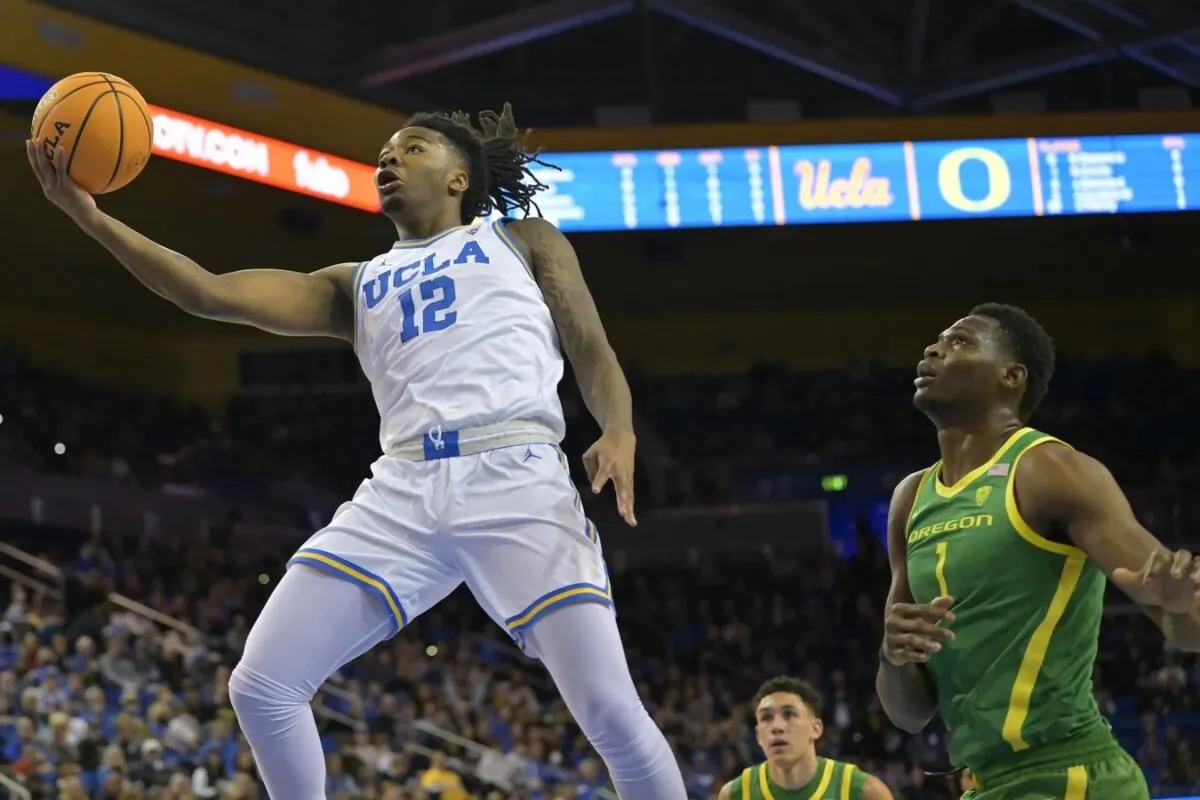 UCLA Bruins guard Sebastian Mack (12) drives past Oregon Ducks center N'Faly Dante (1) for a basket in the first half at Pauley Pavilion presented by Wescom in Los Angeles on Feb. 3, 2024. (Jayne Kamin-Oncea/USA TODAY Sports via Field Level Media)