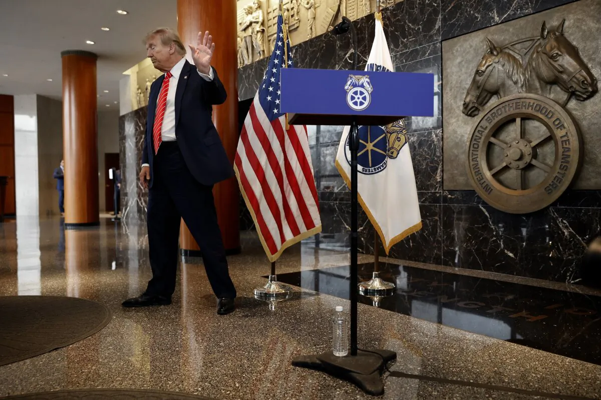 Republican presidential candidate and former President Donald Trump waves goodbye to reporters following a meeting with the International Brotherhood of Teamsters at the union's headquarters in Washington on Jan. 31, 2024. (Chip Somodevilla/Getty Images)