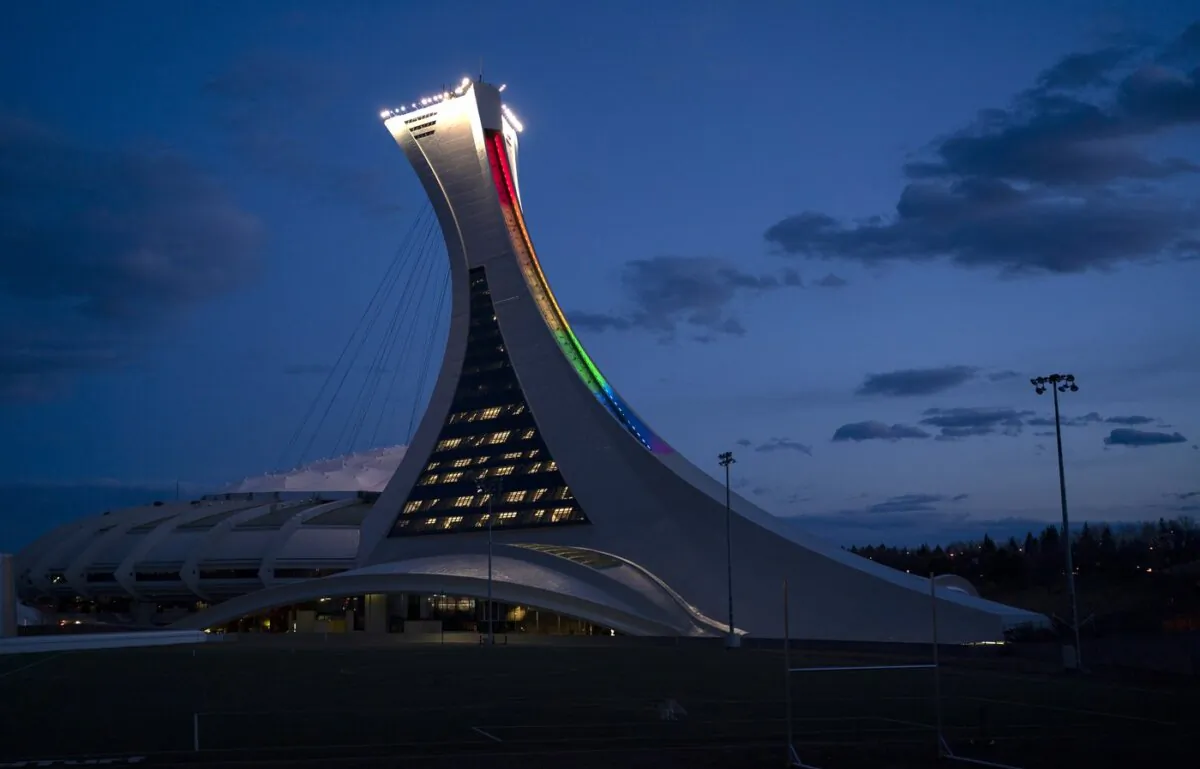 The Olympic Stadium is lit to the colours of the rainbow in solidarity with health-care workers in Montreal, on April 6, 2020. (The Canadian Press/Paul Chiasson)
