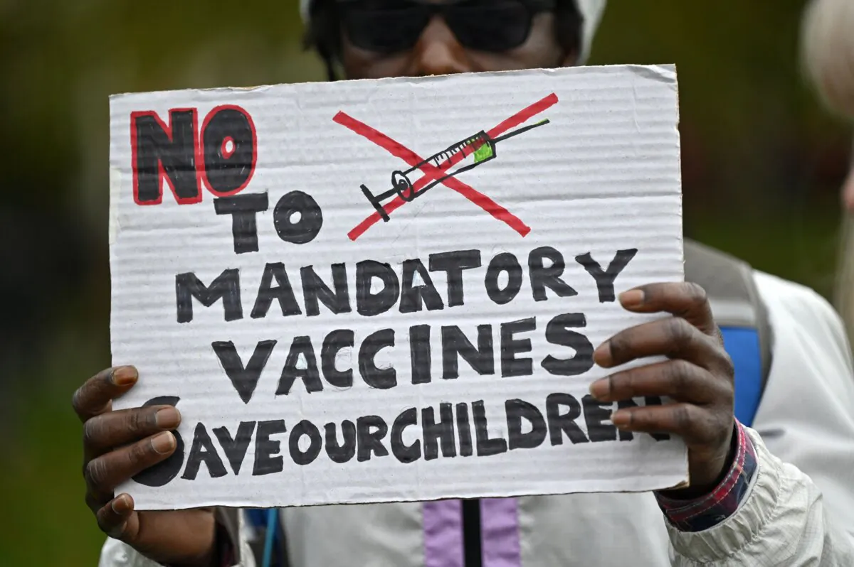 A protester holds up a placard at a demonstration against vaccinations and government restrictions in London on Oct. 17, 2020. (Justin Tallis/AFP via Getty Images)