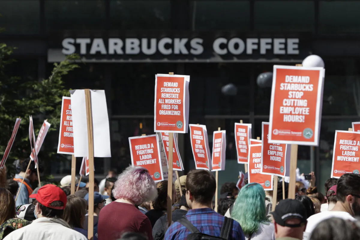 People gather in Seattle's Westlake Park during a "Fight Starbucks' Union Busting" rally on April 23, 2022. (Jason Redmond/AFP/Getty Images)