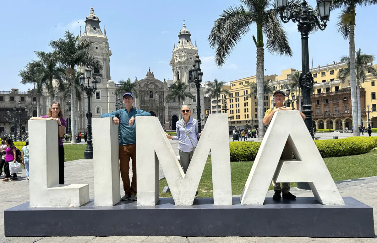 The author, left, and her three companions line up for a picture in Lima's main square, Plaza de Armas. (Colleen Thomas/TNS)
