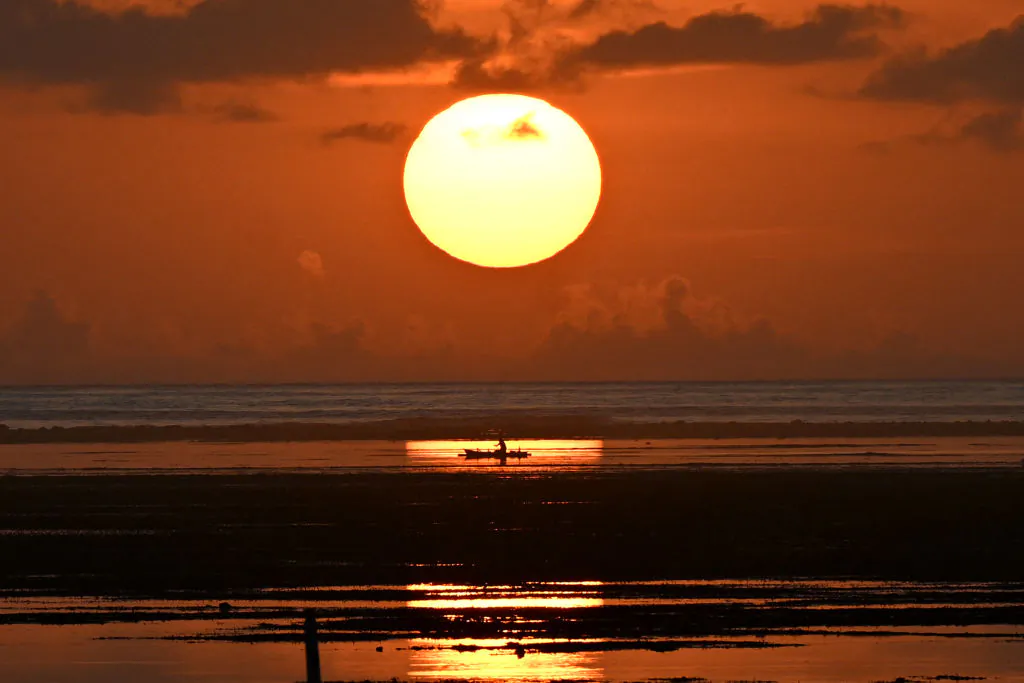 This picture shows a fishing boat during sunrise at a beach in Sanur on the Indonesian resort island of Bali, Indonesia on Dec. 29, 2023. (Sonny Tumbelaka/ AFP via Getty Images)
