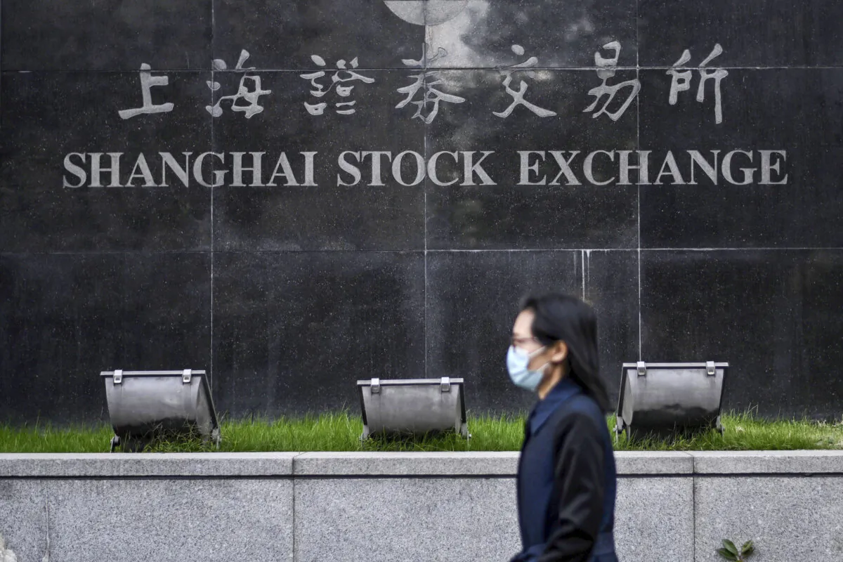 A pedestrian walks past the Shanghai Stock Exchange in Shanghai on Nov. 4, 2020. (Hector Retamal/AFP via Getty Images)