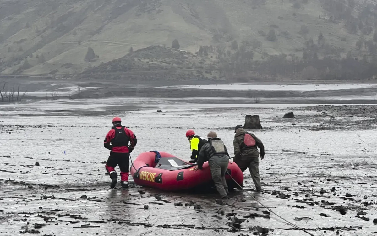 Volunteers attempt to rescue two deer that were stuck in mud in Copco Lake, Calif., on Jan. 27, 2024, after officials began draining the lake as part of a process to remove two dams. The two deer were later euthanized by state fish and wildlife personnel after rescue attempts failed. (Courtesy of Hornbrook Fire Protection District)