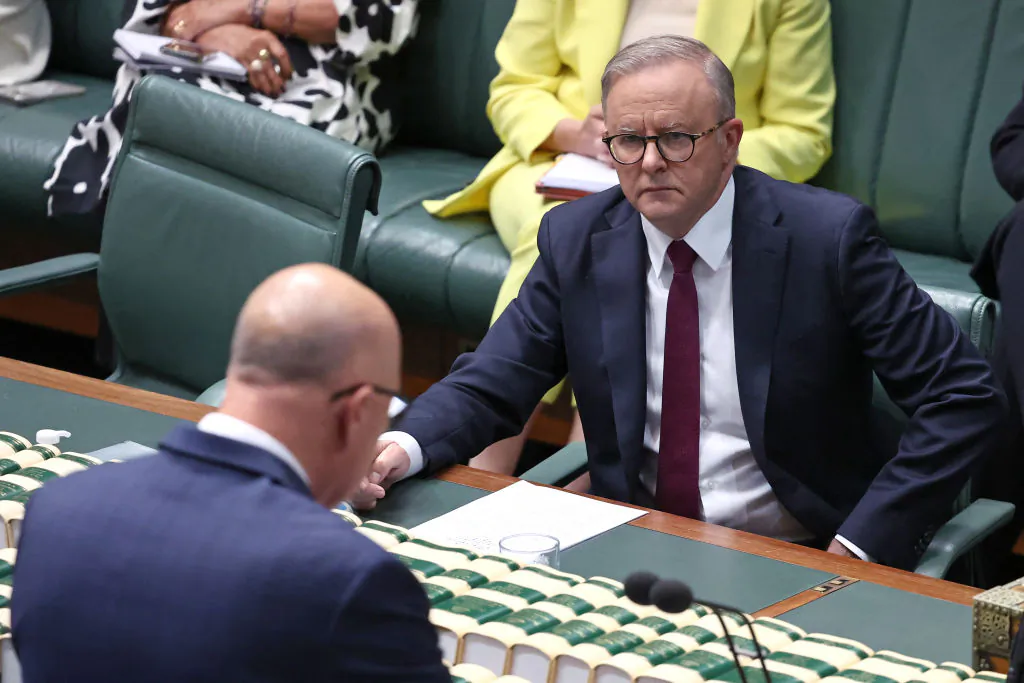 Australian Prime Minister Anthony Albanese (R) listens to the leader of the opposition Liberal Party Peter Dutton speak in the House of Representatives at Parliament House in Canberra on October 16, 2023. Australians on October 14 roundly rejected greater rights for Indigenous citizens, scuppering plans to amend the country's 122-year-old constitution after a divisive and racially tinged referendum campaign. (David Gray/Via Getty Images)