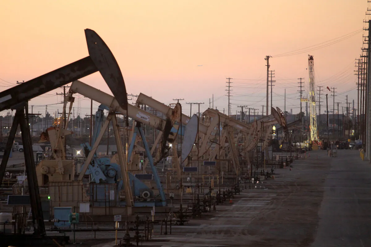 Oil rig pumpjacks, also known as thirsty birds, extract crude from the Wilmington Field oil deposits area near Long Beach, Calif., on July 30, 2013. (David McNew/Reuters)