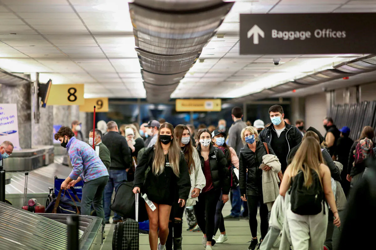 Travelers reclaim their luggage at the airport in Denver, Colorado, on Nov. 24, 2020. (Kevin Mohatt/Reuters)