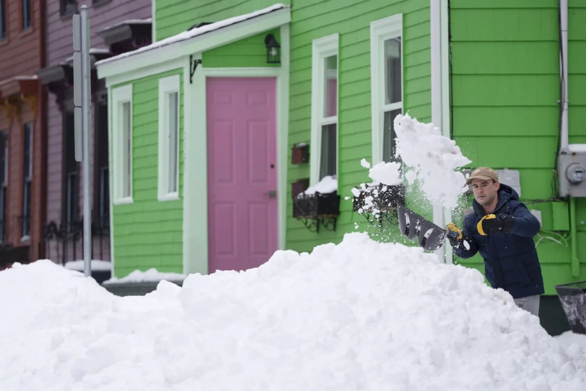 A person shovels snow in Halifax on Feb. 5, 2024. (The Canadian Press/Darren Calabrese)