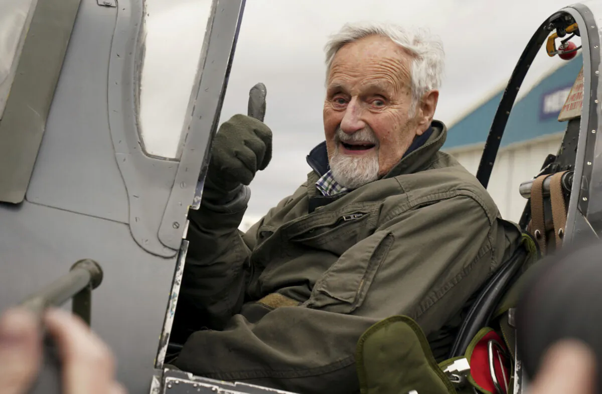 102-year-old Jack Hemmings AFC gestures after flying a Spitfire plane to mark 80th anniversary of the military charity Mission Aviation Fellowship (MAF) at Heritage Hanger at London Biggin Hill in England on Feb. 5, 2024. (Gareth Fuller/PA via AP)