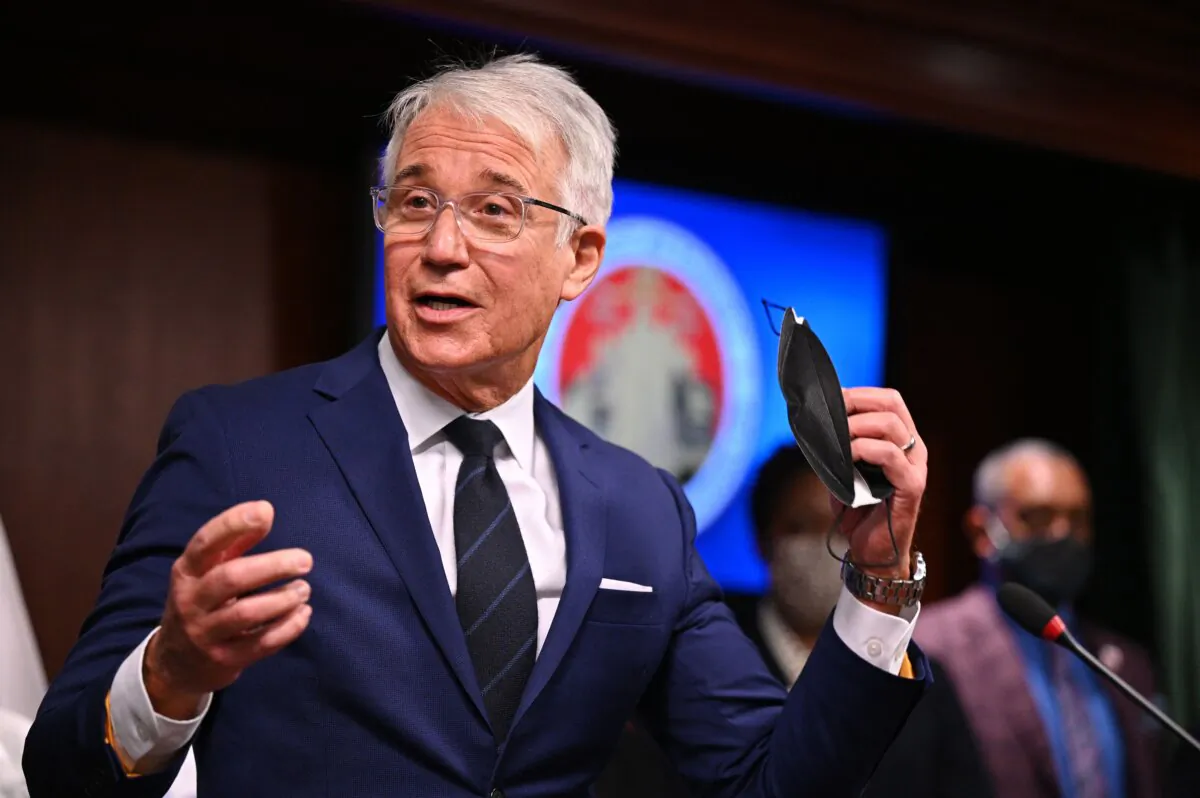 Los Angeles County District Attorney George Gascon removes his mask before speaking at a press conference in Los Angeles on Dec. 8, 2021. (Robyn Beck/AFP via Getty Images)