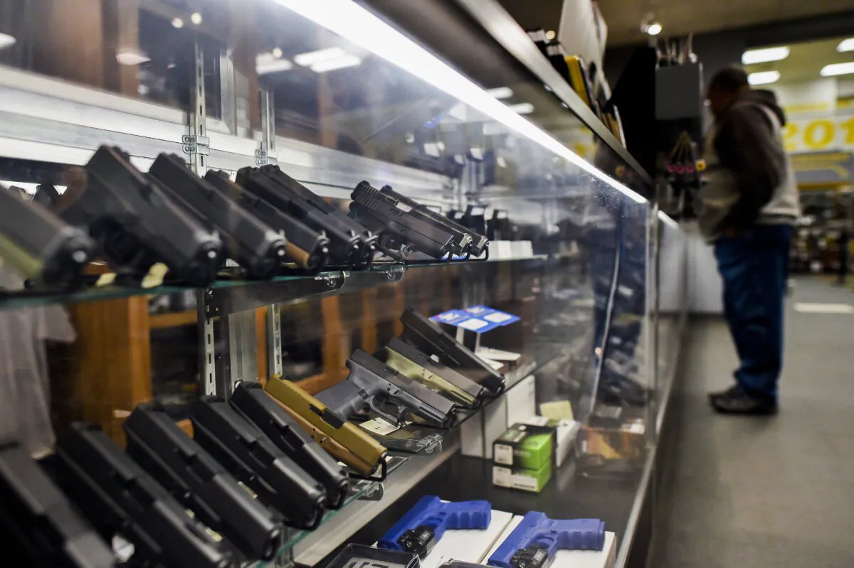 A man looks at handguns at the RTSP shooting range in Randolph New Jersey on December 9, 2015. US President Barack Obama called for tougher gun controls in the wake of the California shootings, starting with a ban on gun purchases for anyone on a US government no-fly list. AFP PHOTO/JEWEL SAMAD / AFP / JEWEL SAMAD        (Photo credit should read JEWEL SAMAD/AFP via Getty Images)