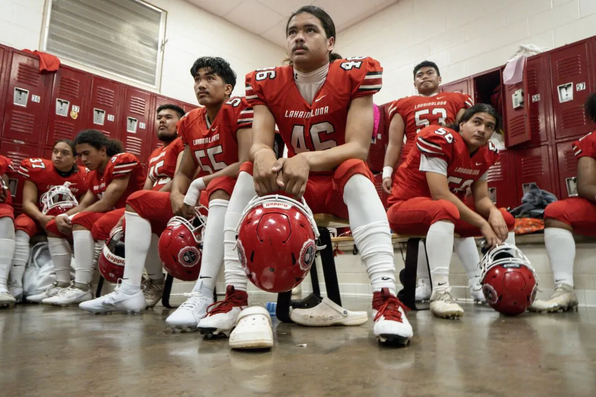 Lahainaluna High School football team players listens to co-head coach Dean Rickard before their homecoming game in Lahaina, Hawaii, on Oct. 21, 2023. (Mengshin Lin/AP Photo)