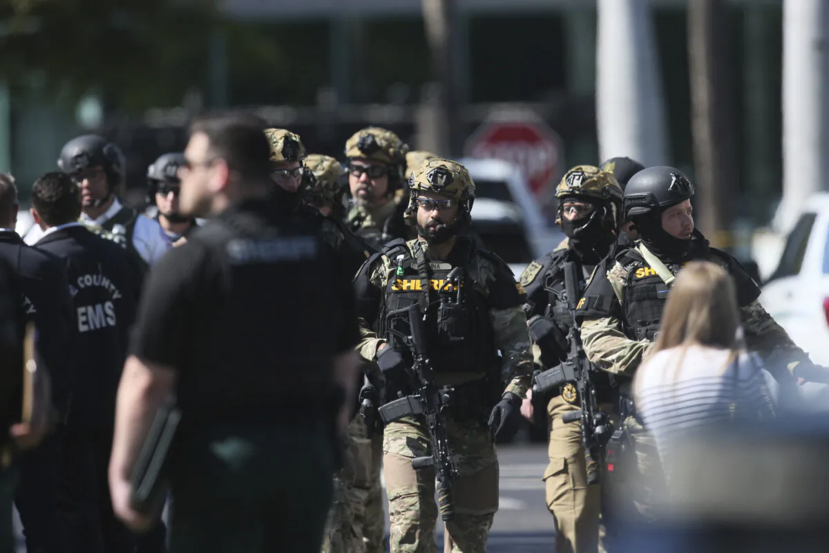 A large number of law enforcement swarmed a hostage situation at the Bank of America building at Bell Tower Shops in Fort Myers, Fla., on Feb. 6, 2024. (Andrew West/The News-Press via AP)
