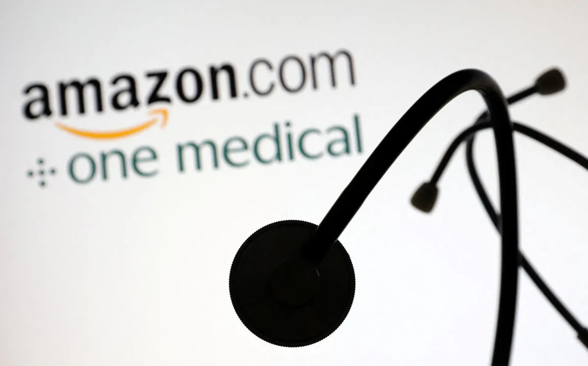 A stethoscope is placed on displayed Amazon.com and One Medical logos in an illustration taken on July 26, 2022. (Dado Ruvic/Illustration/Reuters)