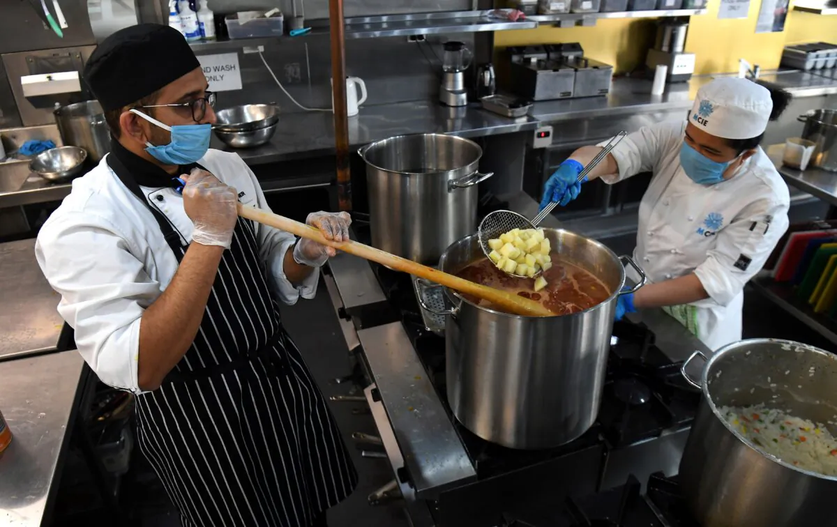 International student volunteer chefs work at the Melbourne City Institute of Education (MCIE) in Melbourne, Australia, on 22 May, 2020. (William West/AFP via Getty Images)