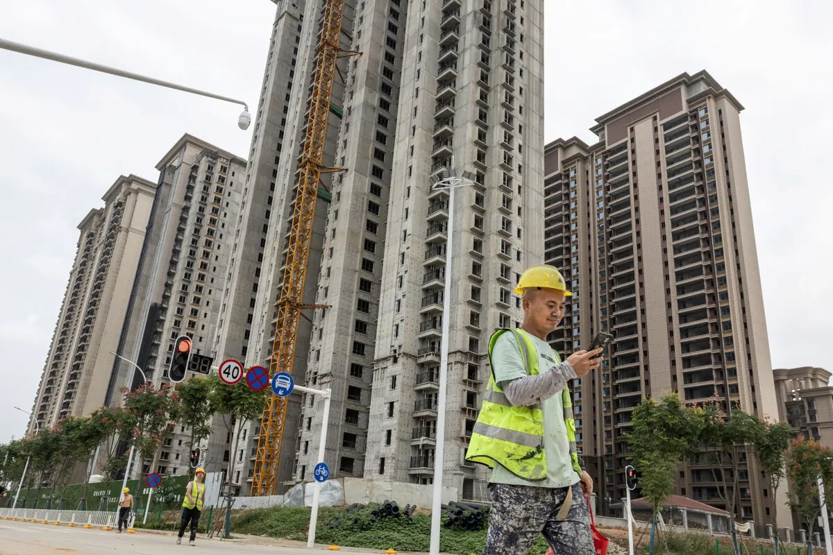 A worker walks past a housing complex under construction by Chinese property developer Evergrande in Wuhan, in China's central Hubei Province, on Sept. 28, 2023. (STR/AFP via Getty Images)