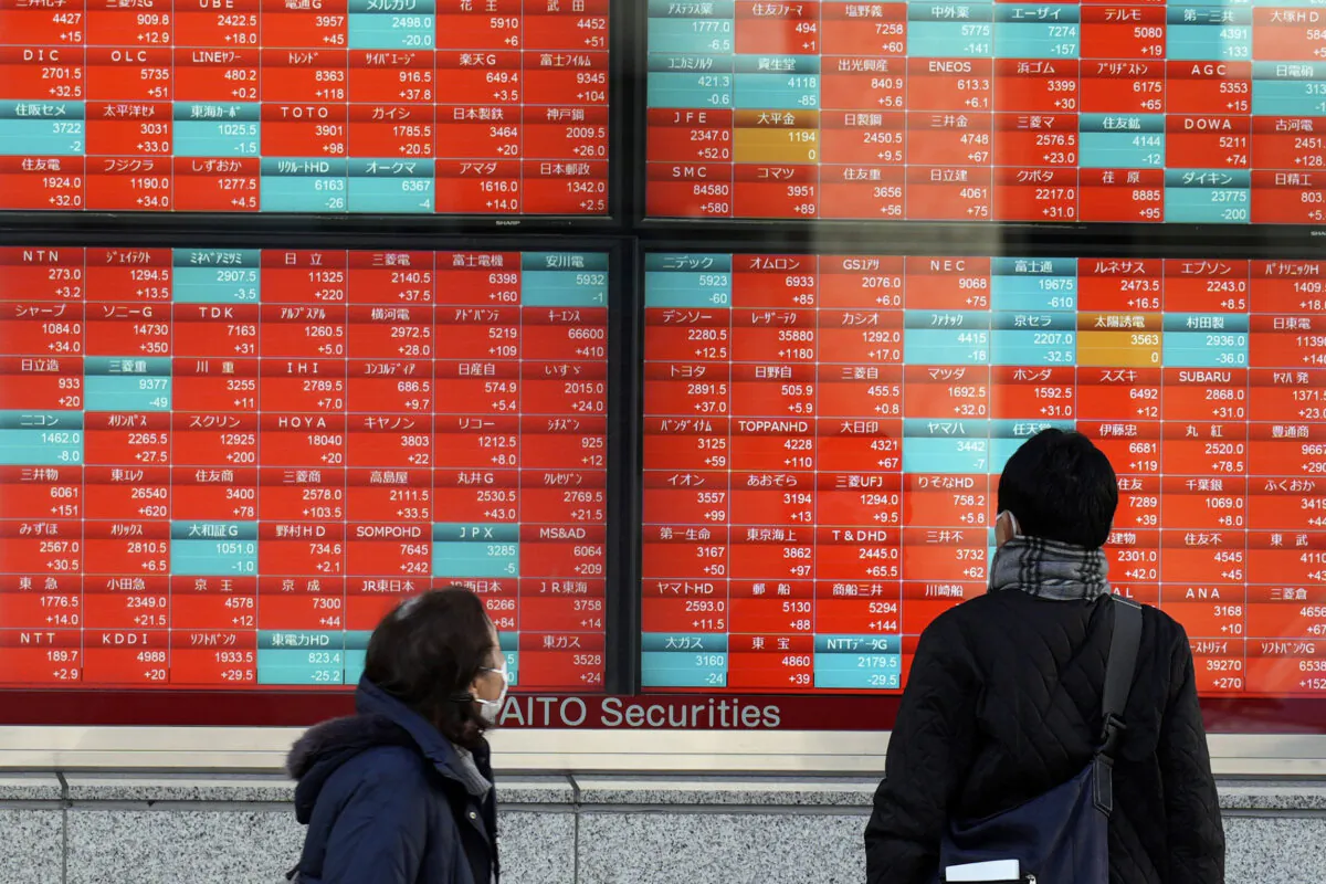People look at an electronic stock board showing Japan's stock prices at a securities firm in Tokyo on Jan. 17, 2024. (Eugene Hoshiko/AP Photo)