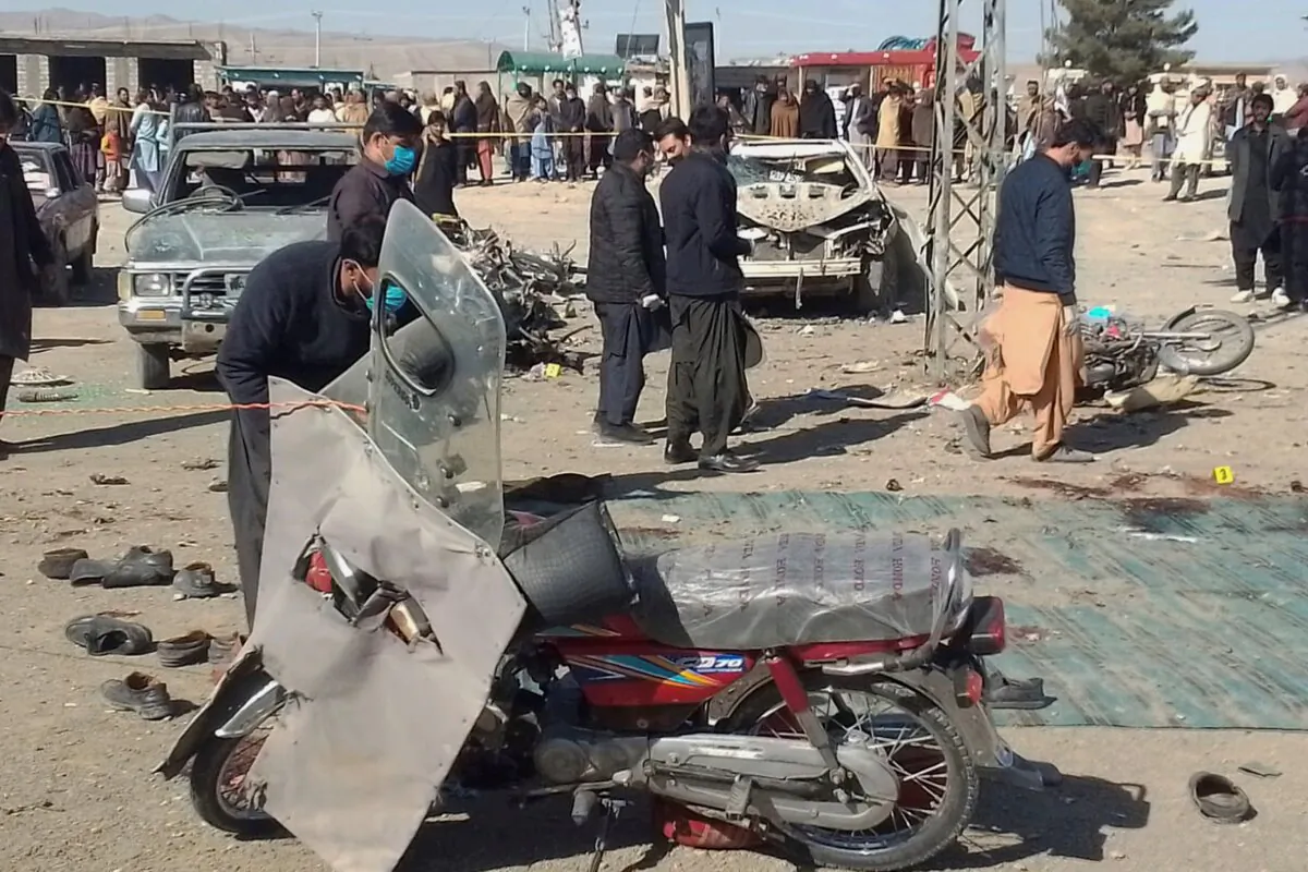 Security officials examine the scene of a bomb blast in Khanozai, Pashin, a district of Pakistan's Baluchistan Province, on Feb. 7, 2024. (Shah Hussain/AP Photo)