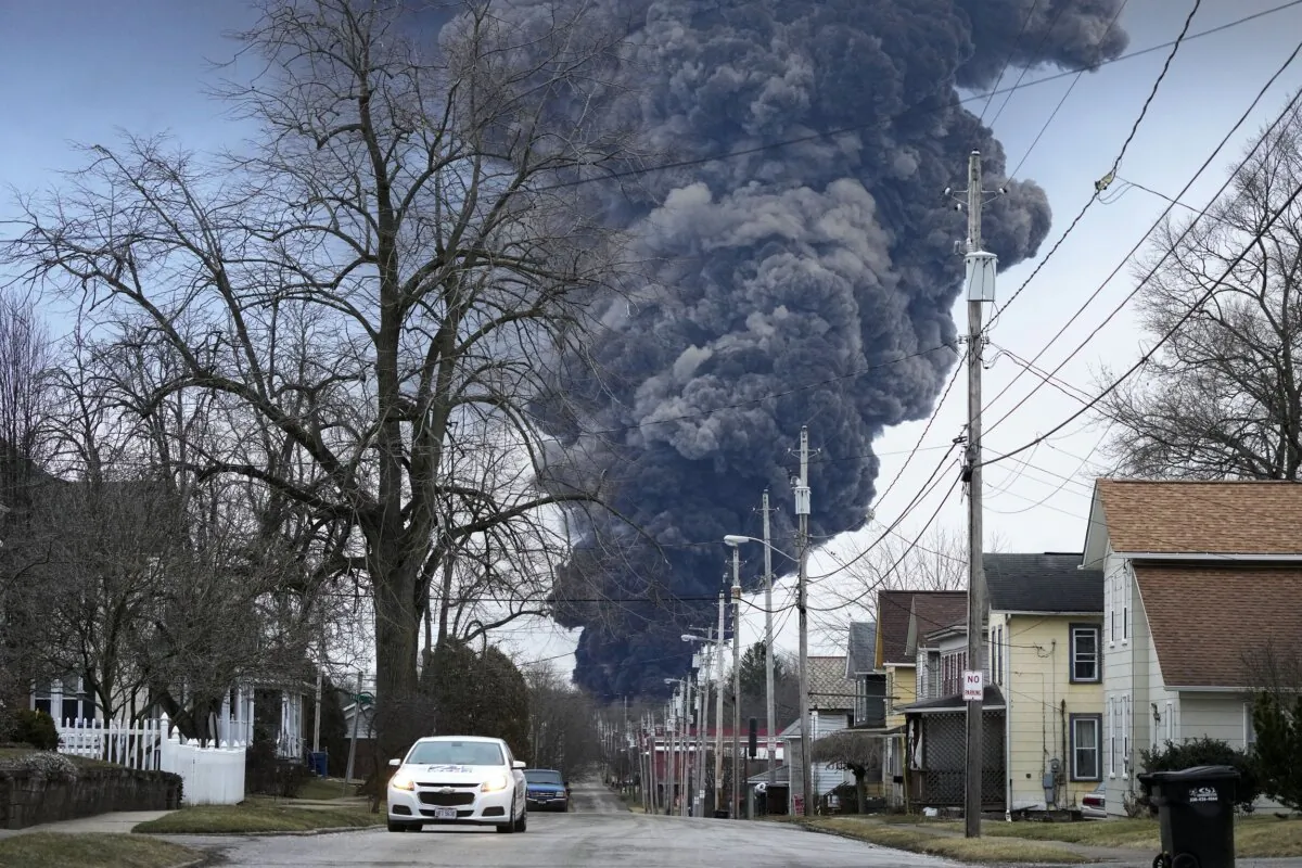 A black plume rises over East Palestine, Ohio, on Feb. 6, 2023, as a result of a controlled detonation of a portion of the derailed Norfolk Southern trains. (Gene J. Puskar/AP Photo)
