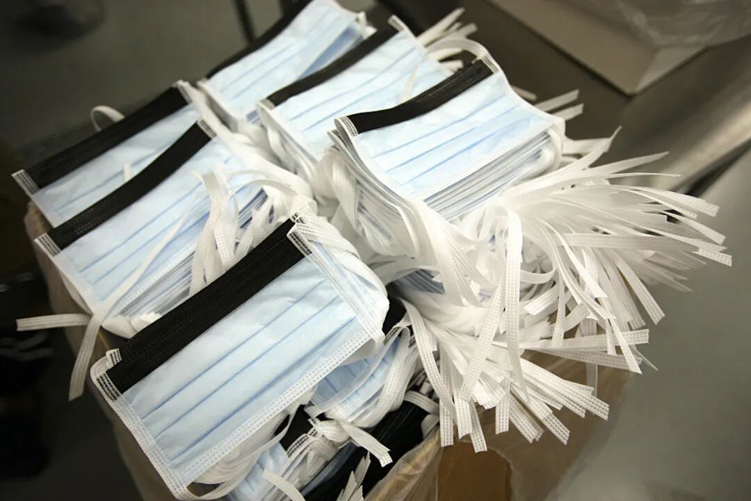 Disposable surgical masks are packed in boxes at Prestige Ameritech in Richland Hills, Texas, on May 3, 2009. (Tom Pennington/Getty Images)