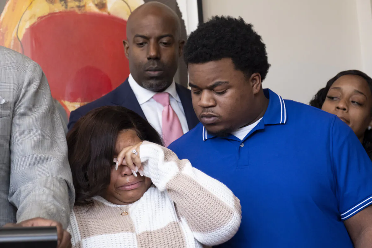 Jessica Ross and Treveon Isaiah Taylor Sr., parents of a baby who was decapitated during delivery, react during a press conference at their lawyers office in Atlanta on Feb. 7, 2024. (Ben Gray/Atlanta Journal-Constitution via AP)