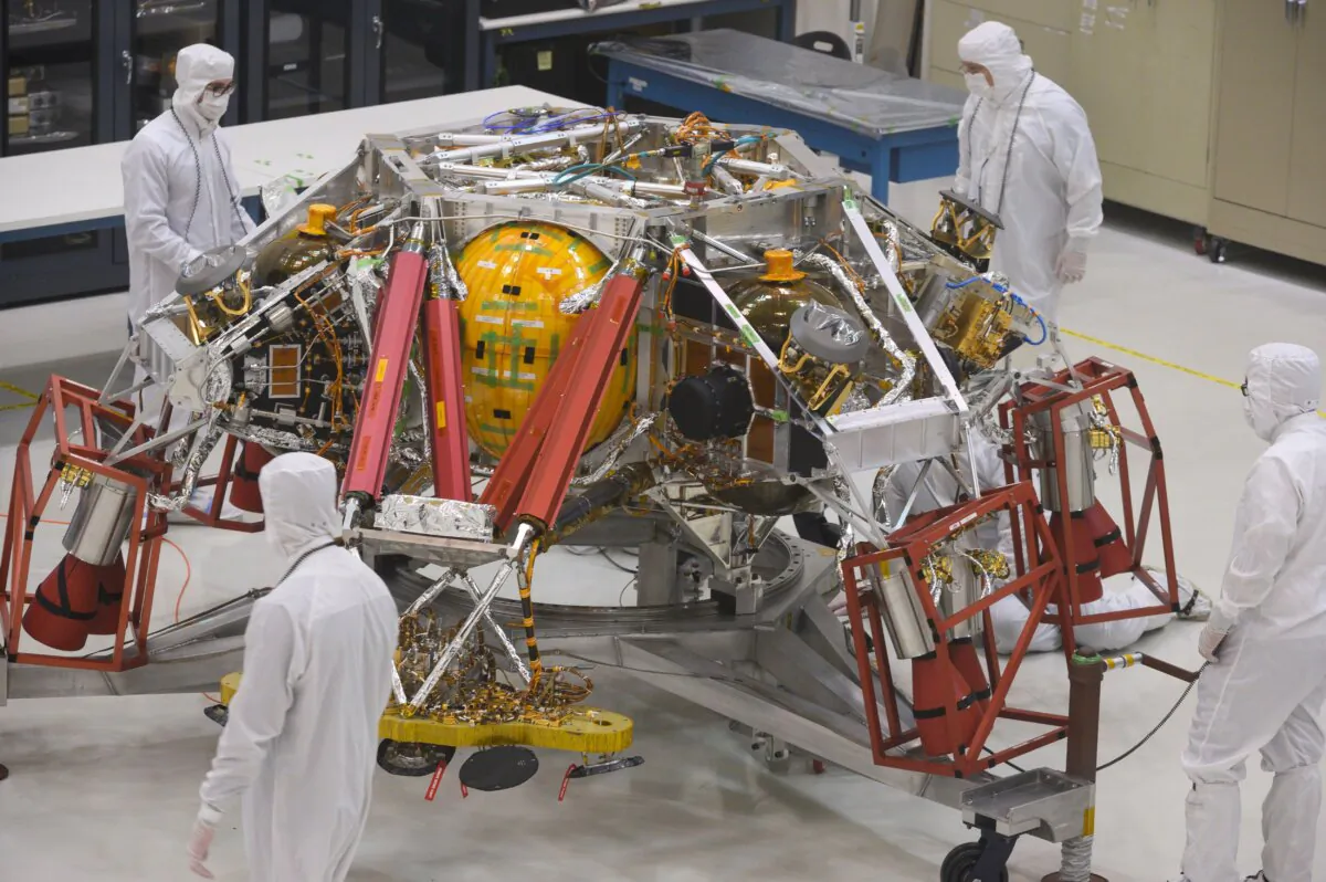 Engineers and technicians examine part of the Mars 2020 spacecraft at NASA's Jet Propulsion Laboratory in Pasadena, Calif., on Dec. 27, 2019. (Robyn Beck/AFP via Getty Images)