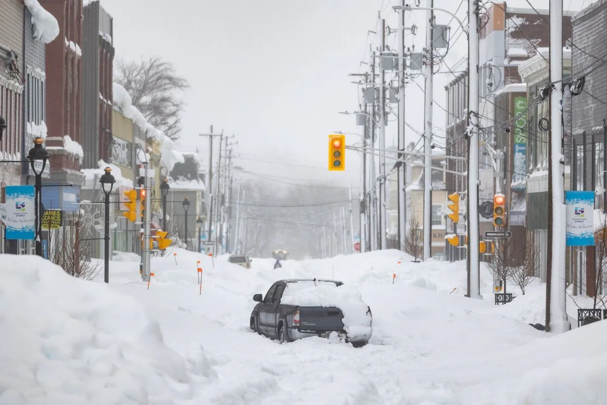 A truck is abandoned on a snow-covered street after a winter storm in Sydney, N.S., on Feb.5, 2024. (The Canadian Press/Shane Wilkie)