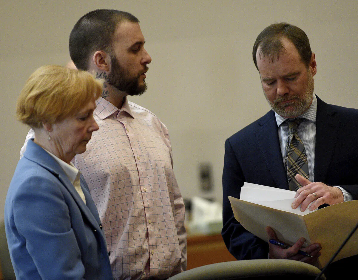 Adam Montgomery (C) stands with his lawyers Caroline Smith and James Brooks as they await potential jurors to enter the courtroom for jury selection ahead of his murder trial at Hillsborough County Superior Court in Manchester, N.H, on Feb. 6, 2024. (David Lane/Union Leader via AP, Pool)
