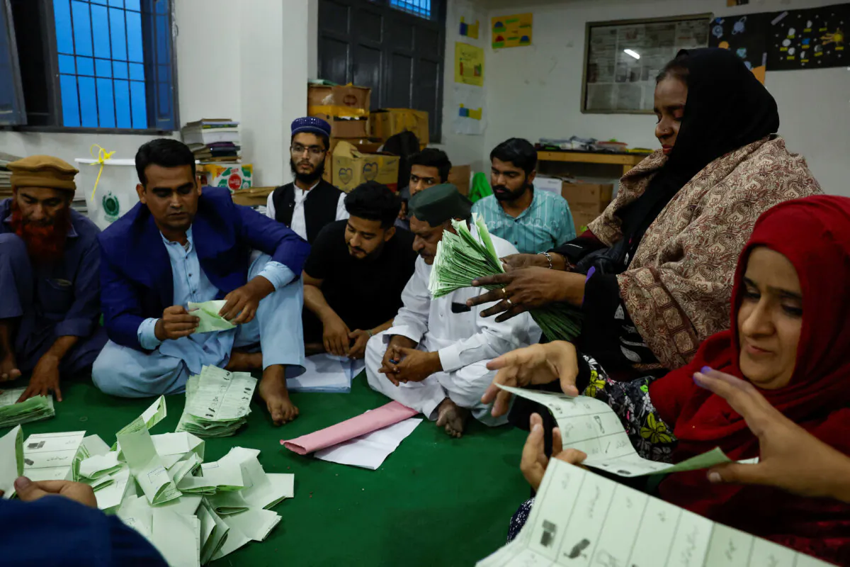 Polling officers count ballot papers during the general election in Karachi, Pakistan, on Feb. 8, 2024. (Akhtar Soomro/Reuters)