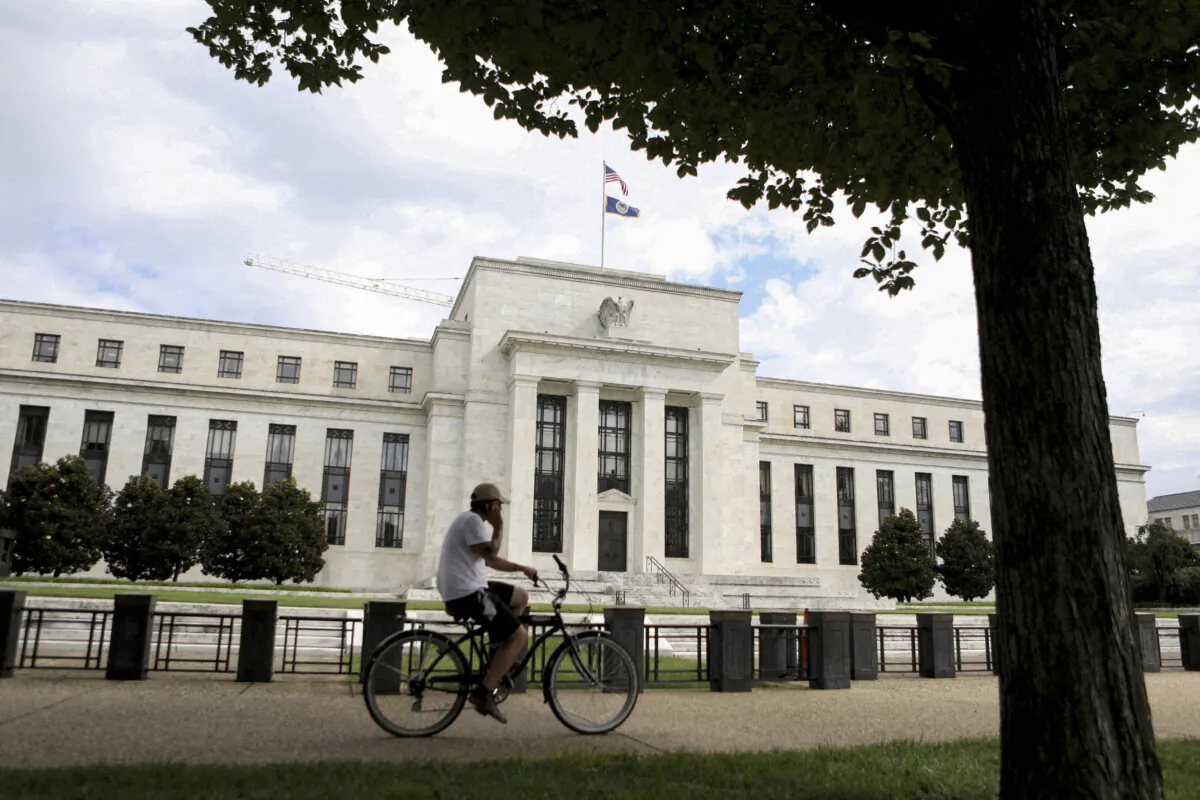 A cyclist passes the Federal Reserve building in Washington, D.C., on Aug. 22, 2018. (Reuters/Chris Wattie/File Photo)