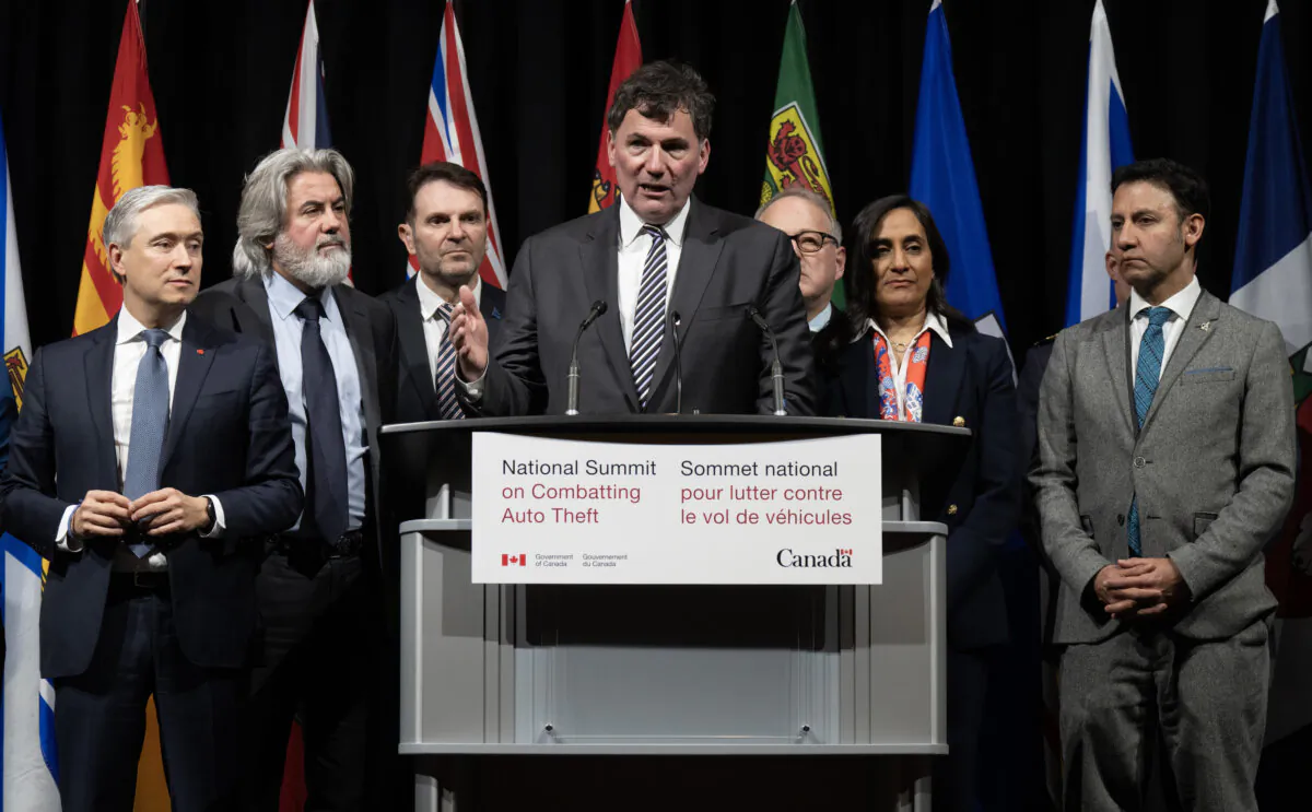 Cabinet members surround Minister of Public Safety Dominic LeBlanc as he speaks during a news conference at the National Summit on Combatting Auto Theft, in Ottawa on Feb. 8, 2024. (The Canadian Press/Adrian Wyld)