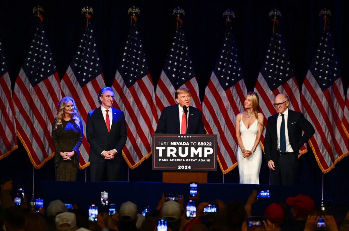 North Dakota Gov. Doug Burgum and his wife Kathryn (L), Jets owner Woody Johnson and his wife Suzanne (R) listen to former President and 2024 presidential hopeful Donald Trump speak during a Caucus Night watch party in Las Vegas on Feb. 8, 2024. (Patrick T. Fallon/AFP via Getty Images)