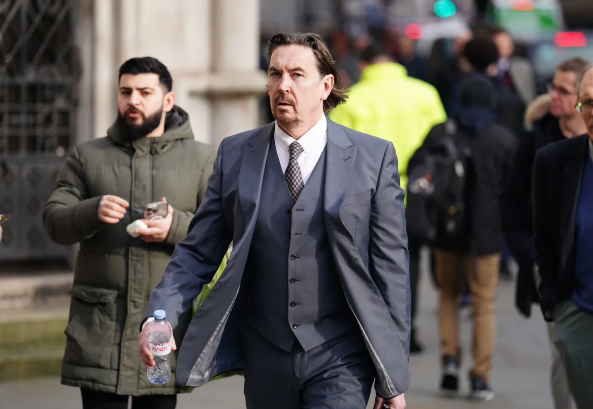 Richard Hall (centre) pictured outside the High Court in central London on Jan. 29, 2024. (Jordan Pettitt/PA Wire)