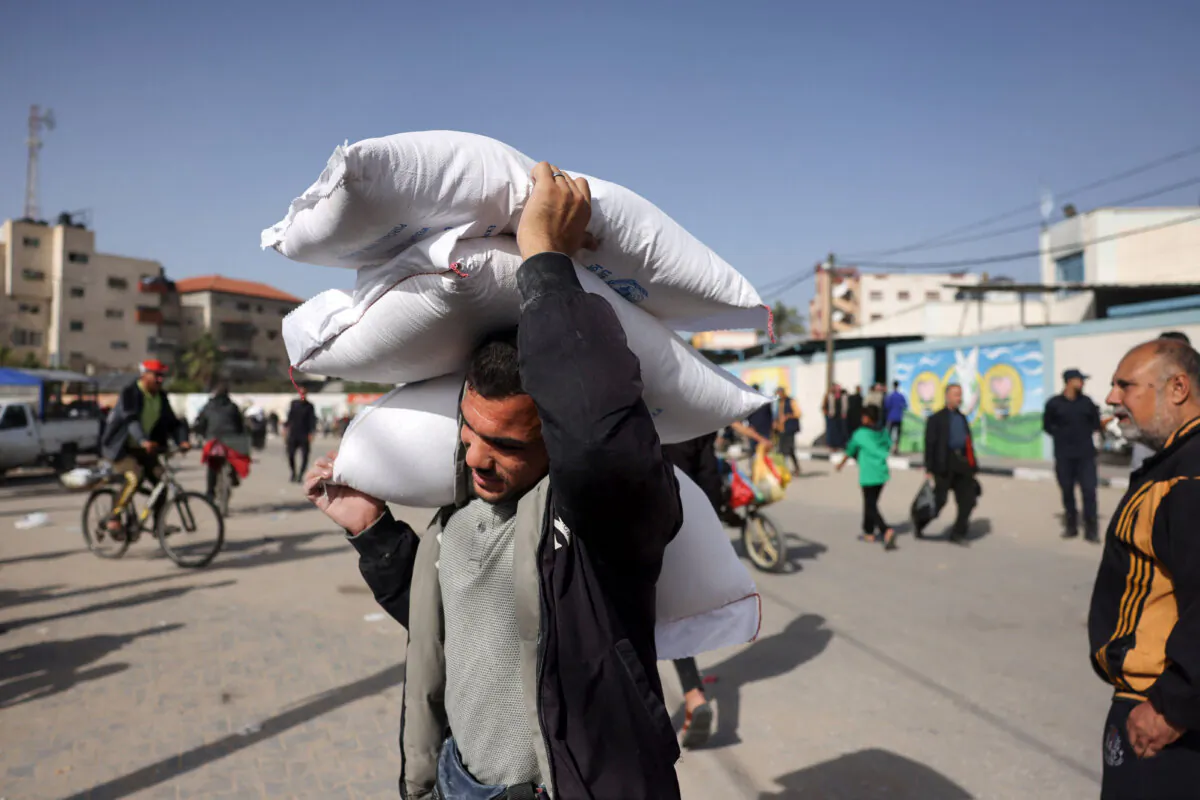 A man carries away bags of humanitarian aid in Rafah in the southern Gaza Strip on Nov. 26, 2023. (Mohammed Abed/AFP via Getty Images)