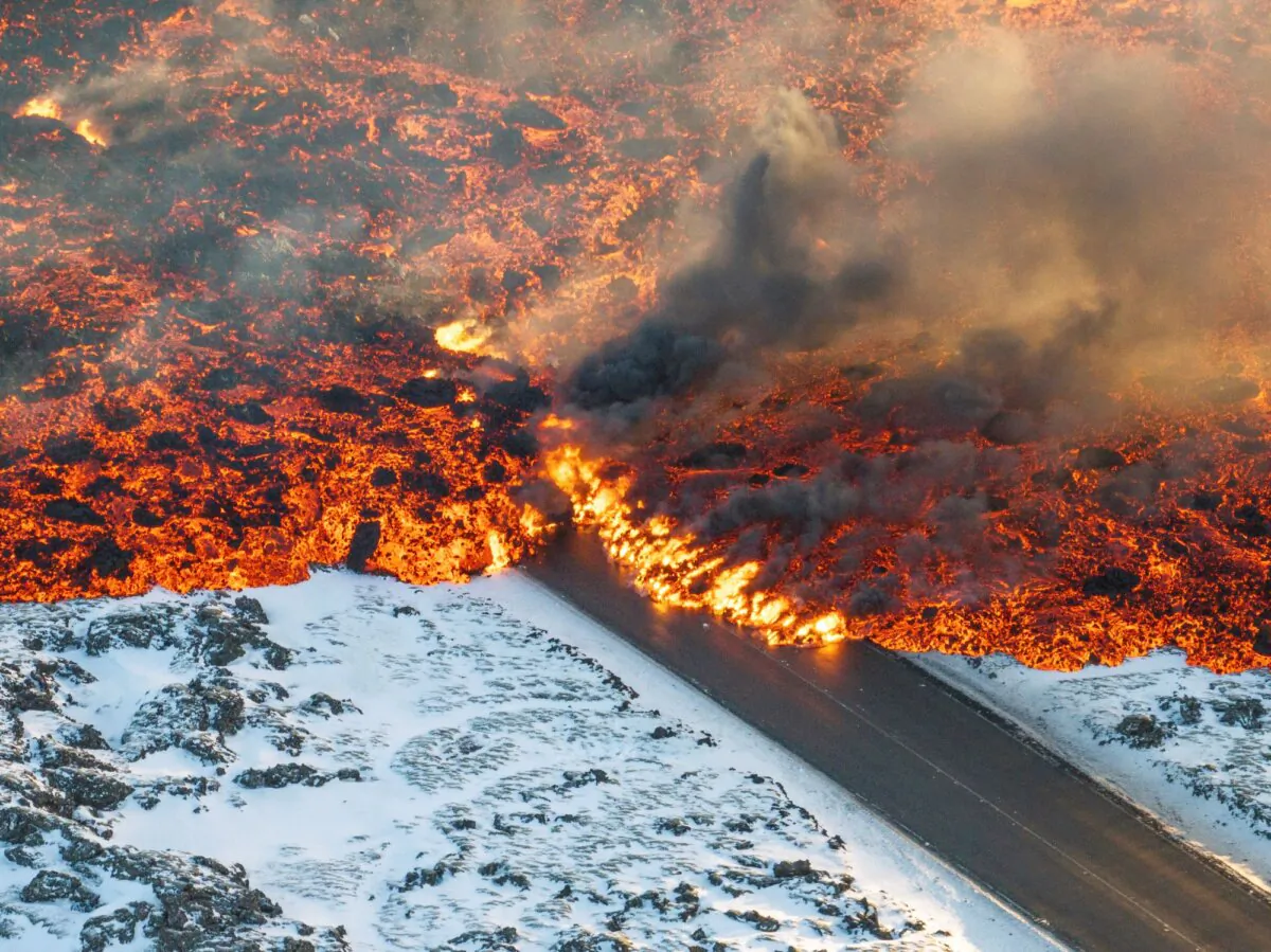 Lava crosses the main road to Grindavík and flows on the road leading to the Blue Lagoon, in Grindavík, Iceland, on Feb. 8, 2024. (Marco Di Marco/AP Photo)