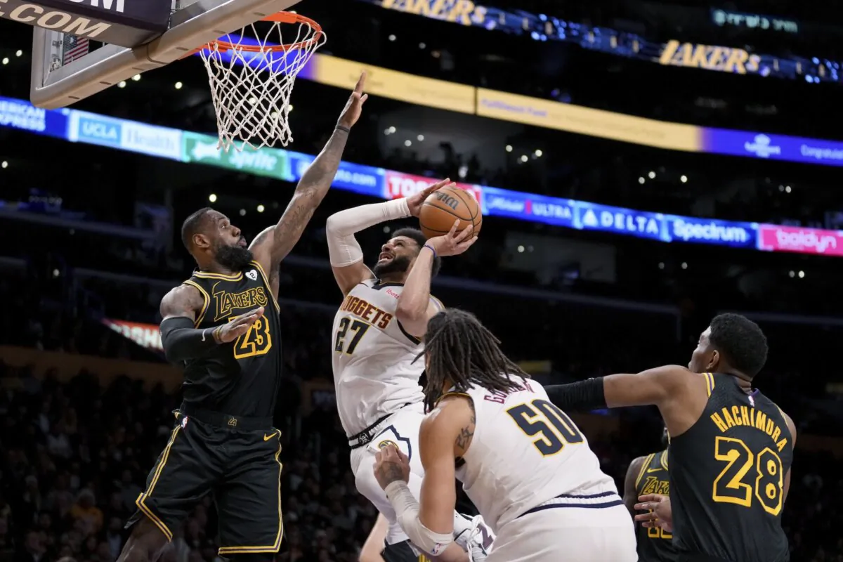Denver Nuggets guard Jamal Murray (27) drives to the basket against Los Angeles Lakers forward LeBron James (23) during the second half of an NBA basketball game in Los Angeles on Feb. 8, 2024. (Eric Thayer/AP Photo)