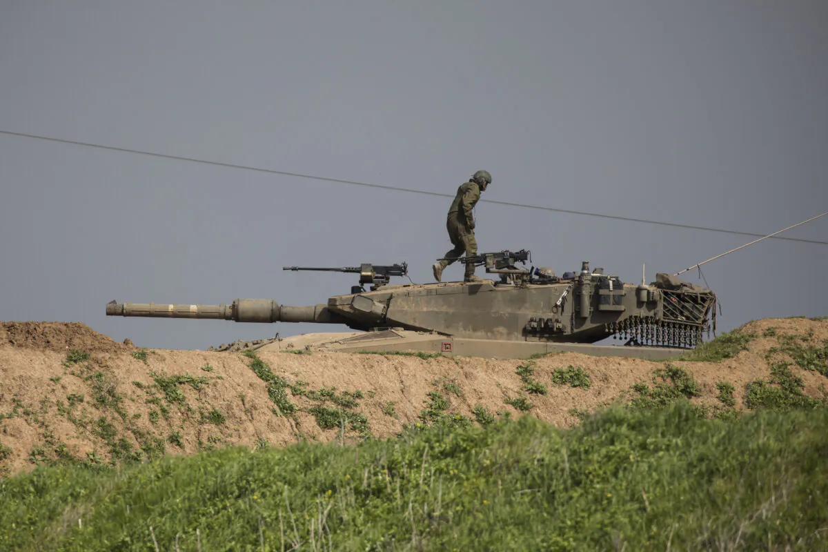 An Israeli soldier stands on a tank near the border with Gaza, in Southern Israel, on Feb. 9, 2024. (Amir Levy/Getty Images)