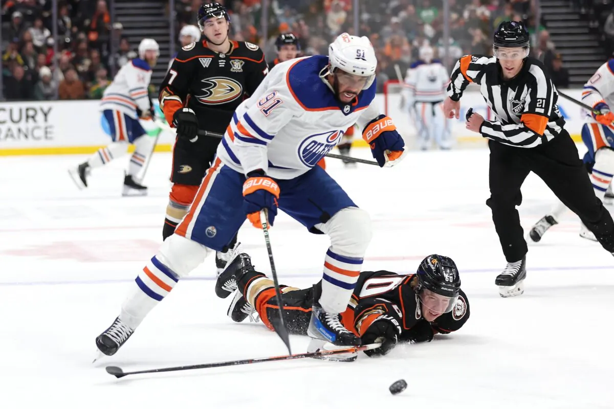 Evander Kane (91) of the Edmonton Oilers skates past Jackson LaCombe (60) of the Anaheim Ducks and scores an empty net goal during the third period of a game in Anaheim, Calif., on Feb. 9, 2024. (Sean M. Haffey/Getty Images)
