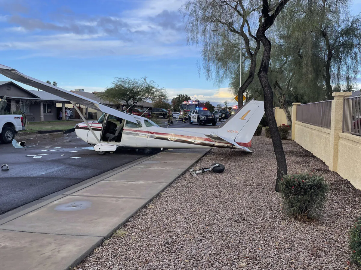 This photo provided by Goodyear Police Department shows a plane after an emergency crash landing on a neighborhood street in Goodyear, Ariz., Saturday, Feb. 10, 2024. (Goodyear Police Department via AP)