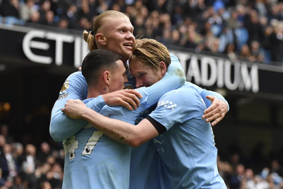 Manchester City's Erling Haaland celebrates with his teammates after scoring his side's second goal during the English Premier League soccer match between Manchester City and and Everton in Manchester, England, on Feb. 10, 2024. (AP Photo/Rui Viera)