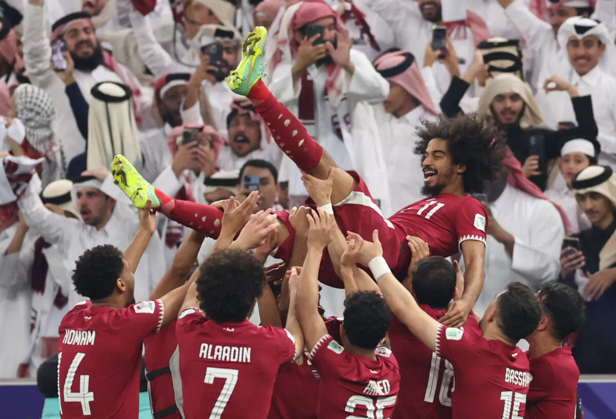 Akram Afif of Qatar celebrates with team mates following their sides victory in the AFC Asian Cup final match between Jordan and Qatar in Lusail City, Qatar on Feb. 10, 2024. (Robert Cianflone/Getty Images)