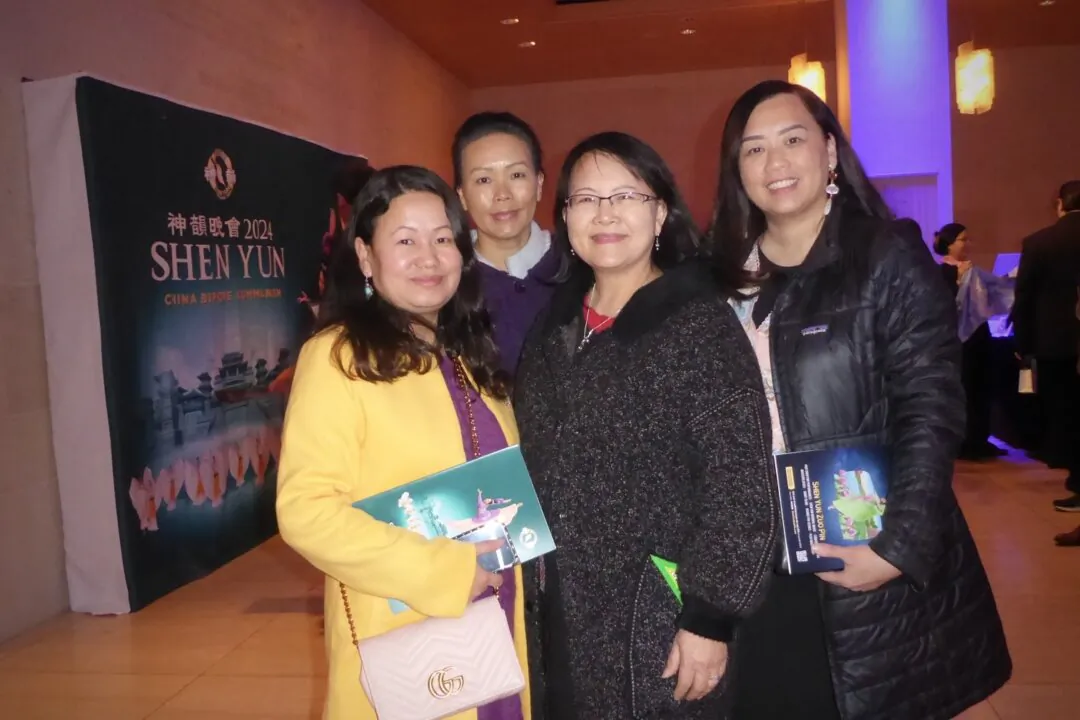 Mai Zong Vue (2nd R) and Hmong Institute members enjoyed Shen Yun at the Overture Center for the Arts after seeing a performance the evening of Feb. 10, 2024. (Frank Liang/The Epoch Times)