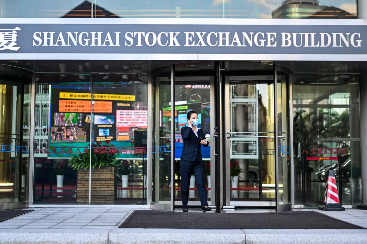 A woman leaves the stock exchange building in Shanghai, China, on Nov. 4, 2020. (Hector Retamal/AFP via Getty Images)